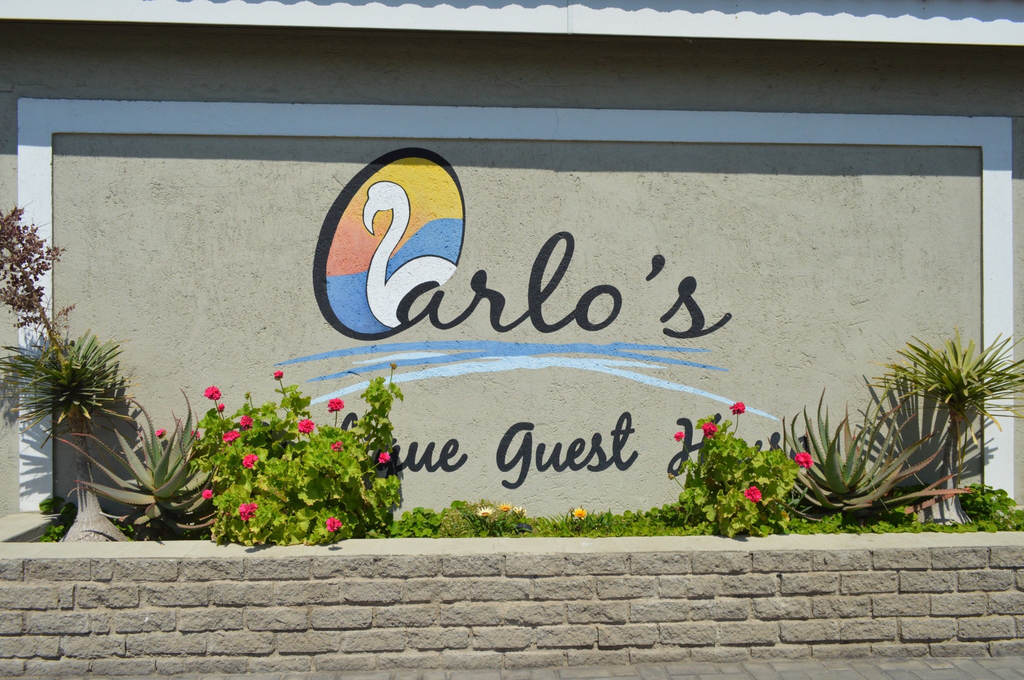 Carlo’s guesthouse signage and garden