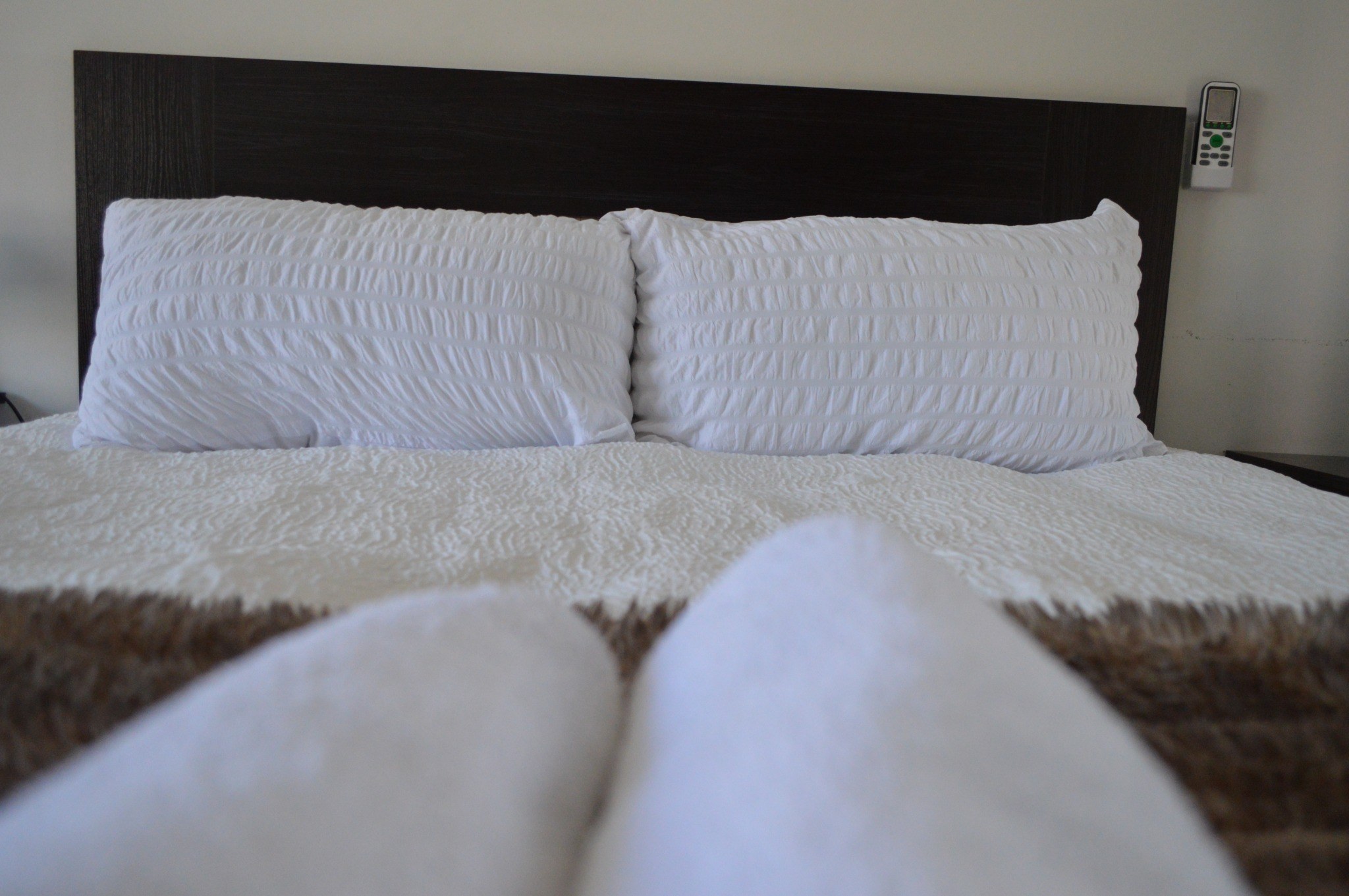 Comfortable guest room with white bedding