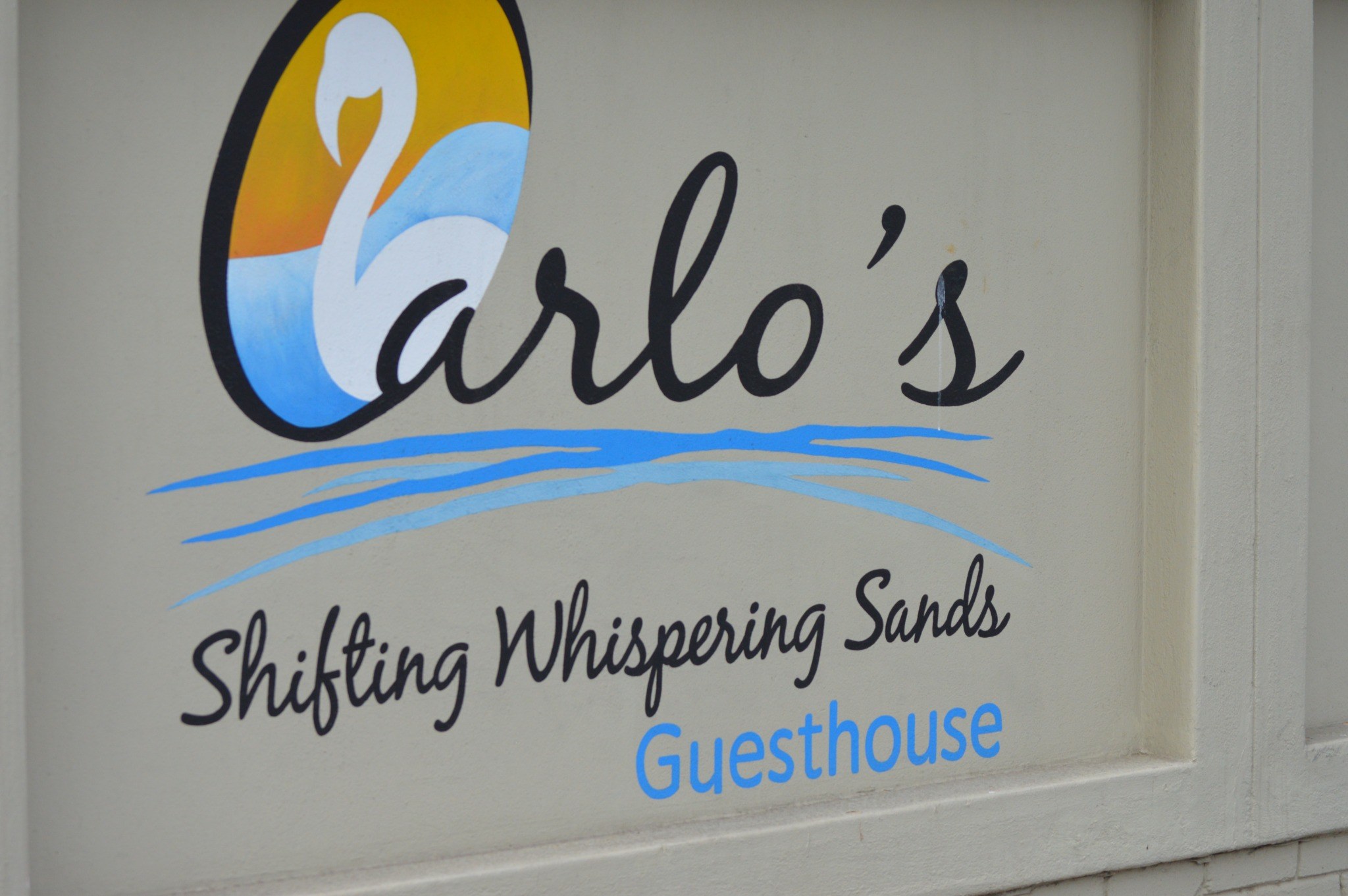 Carlo’s Shifting Whispering Sands Guesthouse signage