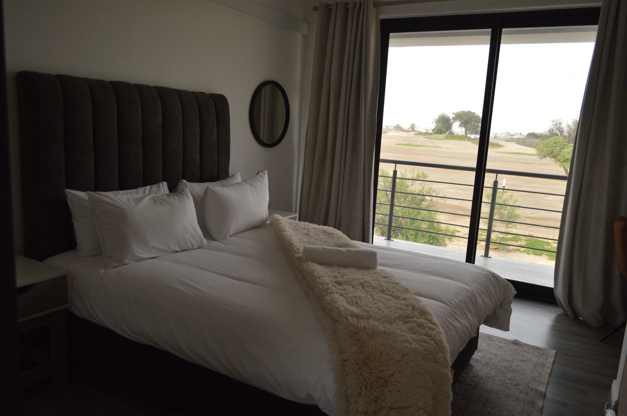 Guest room opening onto a scenic balcony